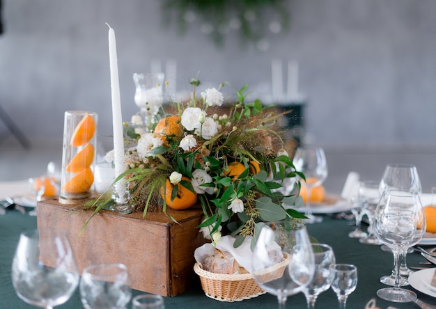 Table Serving with Floral Composition and Oranges on a Green Restaurant Table – Free Download