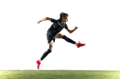 Young Female Football Player Kicking Ball in Sportwear – Free Stock Photo for Download