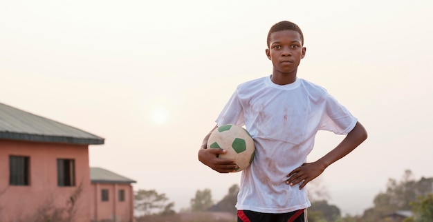 Portrait of African Child Holding Football – Free Download