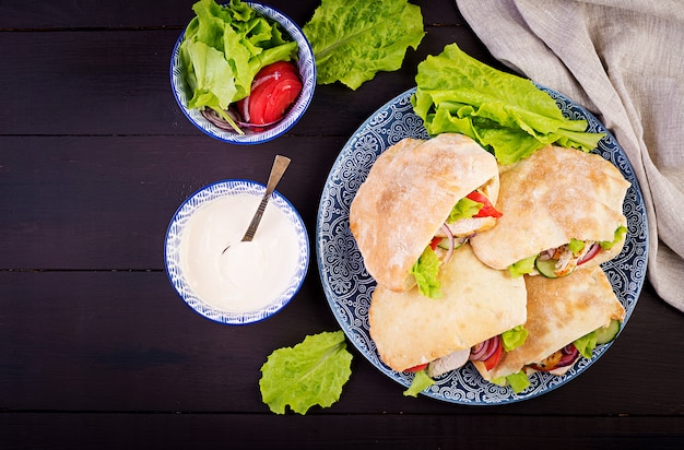 Pita Stuffed with Chicken, Tomato, and Lettuce with Yoghurt Sauce – Free Download