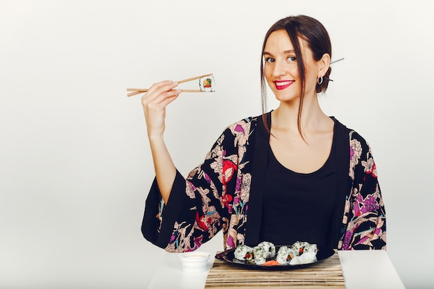 Girl Enjoying Sushi in a Studio – Free Download