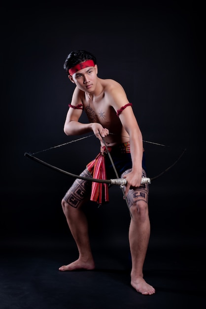 Young Thailand Male Warrior Posing with Bow on Black – Free Stock Photo Download