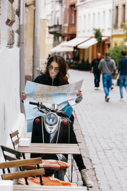 Woman in Unique Sunglasses on Scooter with Tourist Map – Free Download