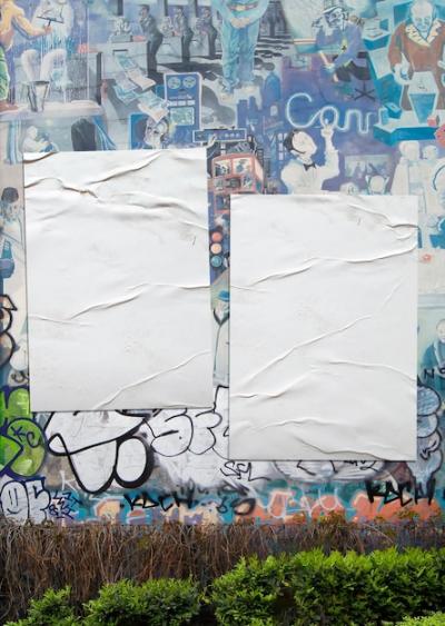 Packed Collection of Crumpled Posters on a Graffiti Wall Background – Free Download