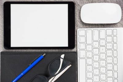 Close-up of Office Desk with Digital Tablet, Mouse, Keyboard, Pen, Eyeglasses, and Diary – Free Download