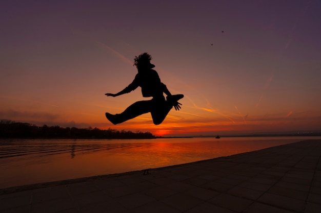 Man Silhouette Jumping at Sunset – Free to Download