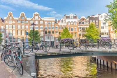 Canal and Buildings in Amsterdam Against the Sky – Free Download