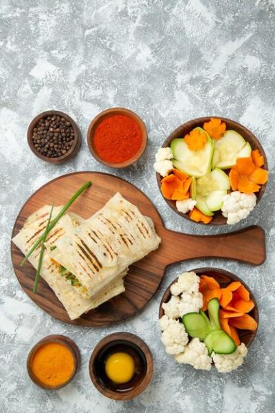 Top View of a Sliced Sandwich with Fresh Vegetables and Seasonings – Free Download