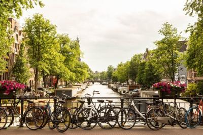 Bicycles Parked on a Bridge Over Canal Against a Sky – Free Download