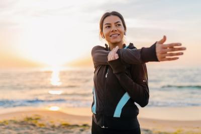 Young Attractive Slim Woman Exercising at Sunrise Beach – Free Download