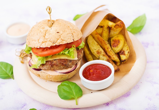 Juicy Hamburger with Cheese, Tomato, and Onion Served with French Fries – Free Stock Photo for Download