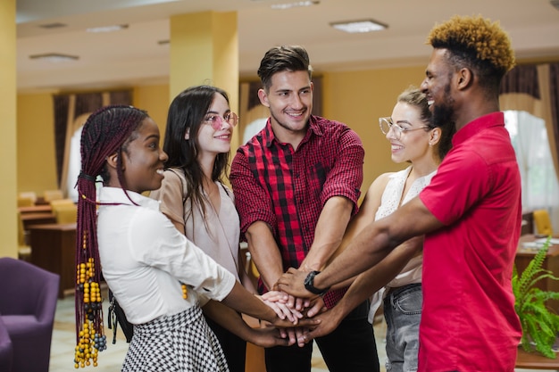 Cheerful People Posing with Hands Stacked – Free to Download