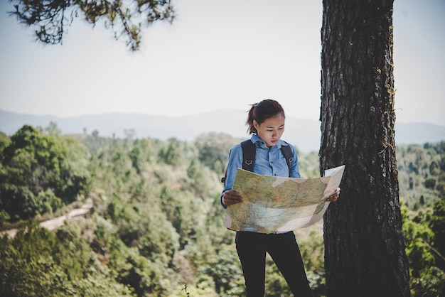 Young Woman Backpacker Reading Map During a Hiking Trip – Free to Download