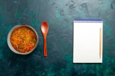 Delicious Vegetable Soup in a Plate on Green Surface – Free Download