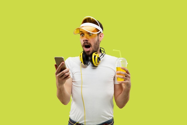 Young Man in Shirt with Headphones and Drink – Free Download