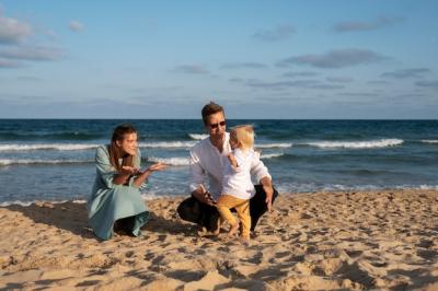 Parent and Baby Enjoying a Beach Sunset – Free Download