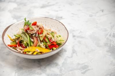 Delicious Chicken Salad with Vegetables on Stained White Surface – Free Download