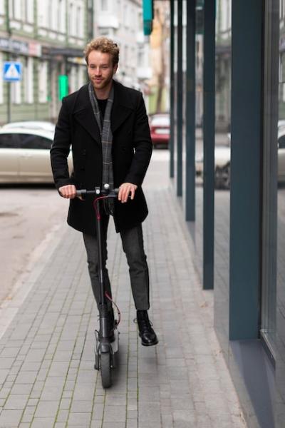 Casual Male Riding an Electric Scooter – Free Download