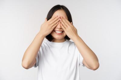 Portrait of an Asian Woman Blindfolded, Smiling in Anticipation – Free Download