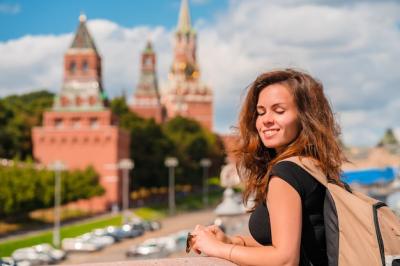 A Woman on a Bridge with the Kremlin in Moscow – Free Download