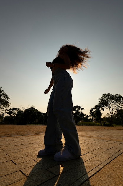 Woman Silhouette Posing at Sunset – Free Download