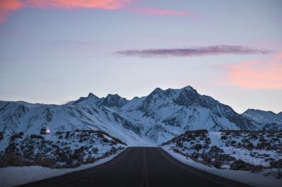 Scenic Road Near Snow-Capped Mountains Under a Vibrant Pink and Purple Sky – Free Download