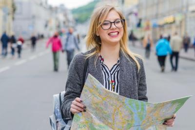 Joyful Traveler Holding a Map – Free Download