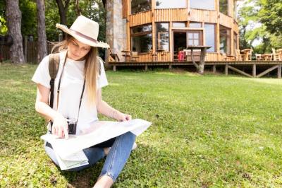 Traveller on Grass Looking at Map – Free Download