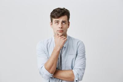 Puzzled Male Student in Light Blue Shirt Deep in Thought – Free Download