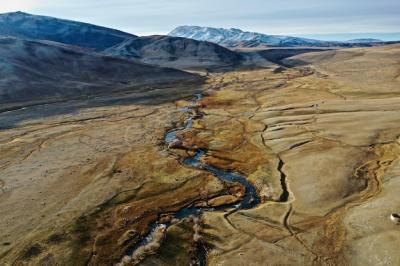 Aerial Shot of a River in a Big Dry Grassland – Free Download