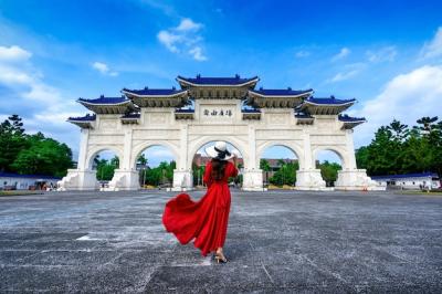 Woman Walking Through the Archway of Chiang Kai Shek Memorial Hall in Taipei, Taiwan – Free Download