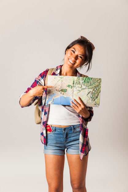 Smiling Tourist Woman Pointing at Map – Free to Download