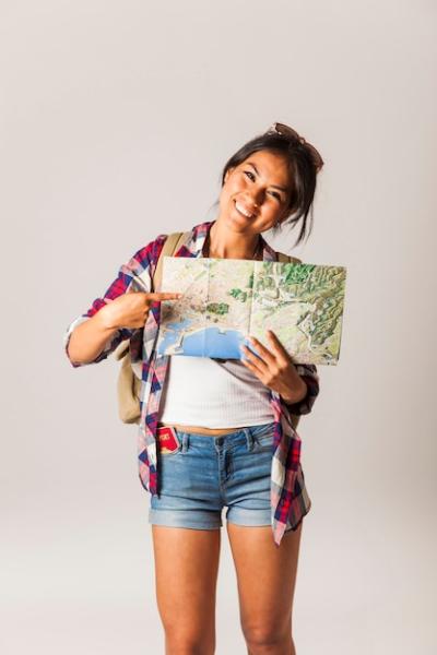 Smiling Tourist Woman Pointing at Map – Free to Download