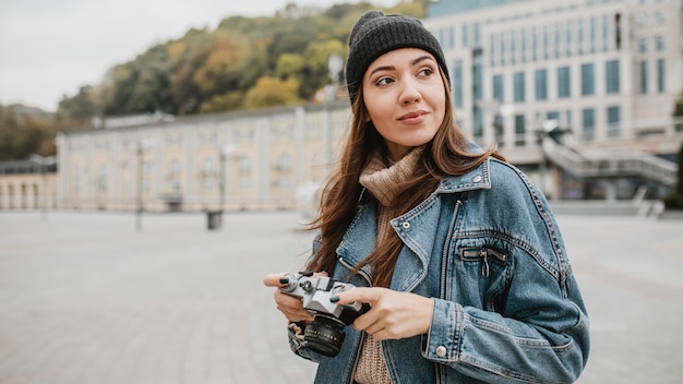 Portrait of a Young Girl Holding a Professional Camera – Free to Download