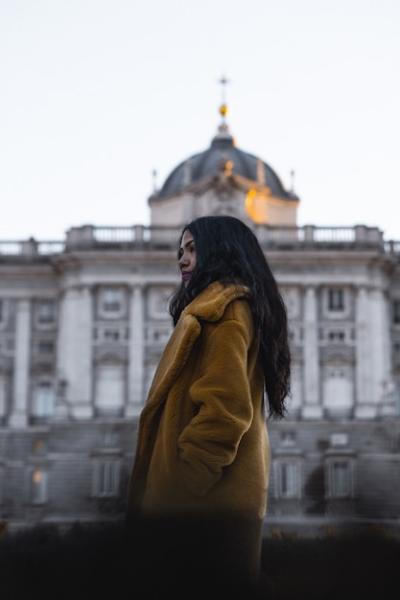 Young Woman in Brown Coat in Front of City Landmark – Free Stock Photo, Download for Free