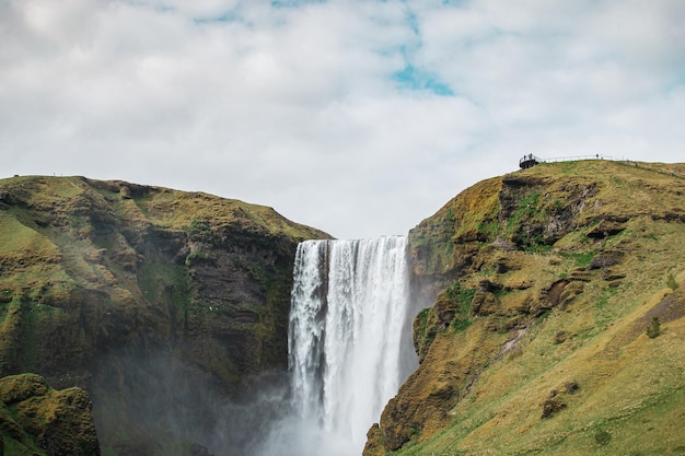 A Serene Green Hill and Waterfall Scene – Free Stock Photo for Download
