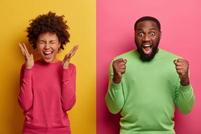 Happy Joyous Woman Celebrates with Excited Bearded Afro American Man – Free Stock Photo Download