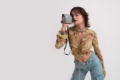 Young Woman in 2000’s Fashion Holding a Camera – Free Stock Photo, Download Free