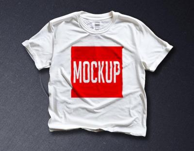 A White T-Shirt with a Red Square on a Black Surface – Free Download