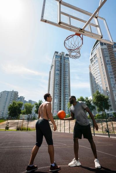 Dynamic Low Angle View of Men Playing Basketball – Free Download