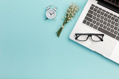 Lily of the Valley Bouquet on a Blue Office Desk with Alarm Clock and Eyeglasses – Free to Download