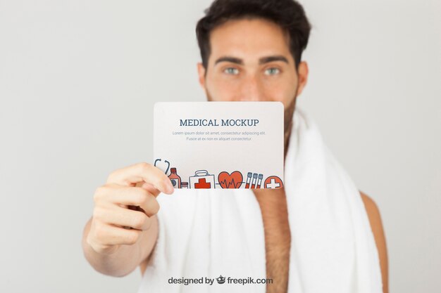 Young Man Holding Card Medical Mockup – Free Download
