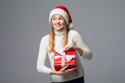 Happy Excited Young Woman in Santa Claus Hat Holding Gift Box – Free Stock Photo for Download
