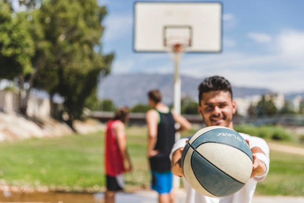 A Male Player Holding a Basketball | Free Download