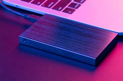High Angle View of an External Hard Drive and Laptop – Free Download