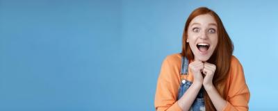 Cute Redhead European Girl with Blue Eyes and Freckles Expressing Surprise