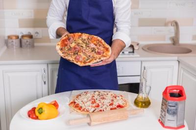 Delicious Cooked Pizza Held by a Man – Free Stock Photo, Download for Free