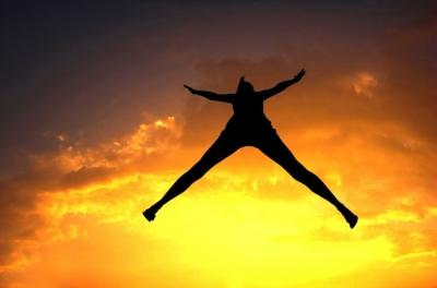 Silhouette of Woman Jumping at Sunset – Free Stock Photo for Download