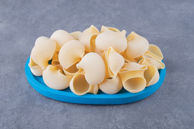 Pile of Conchiglie Pasta on Blue Plate – Free Stock Photo for Download