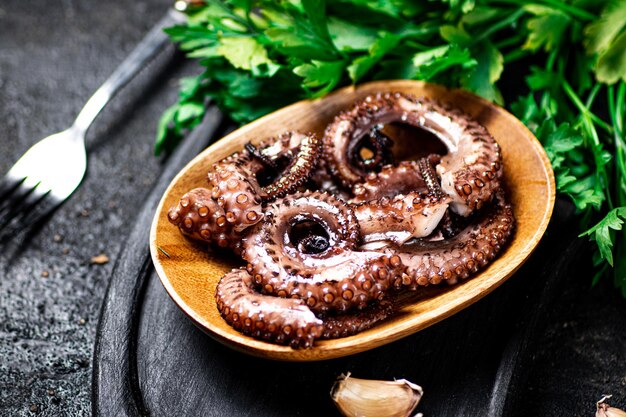 Octopus Pieces on a Cutting Board with Parsley – Free Download